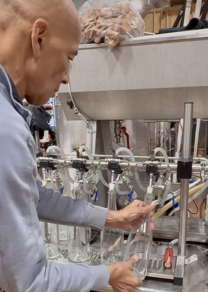 photo of Hye Cider Company owner, Dom Ransay, bottling hard cider